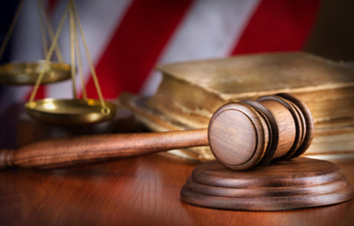 Court gavel with American flag in the background