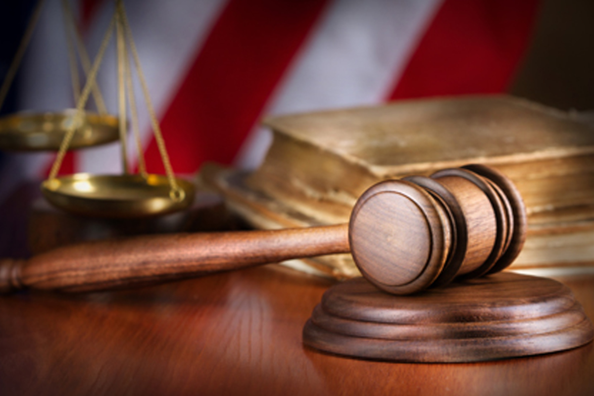 Court gavel with American flag in the background