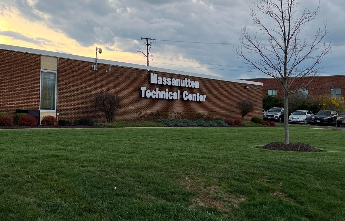 A brick building with big letters on it that says Massanutten Technical Center.