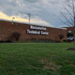 A brick building with big letters on it that says Massanutten Technical Center.
