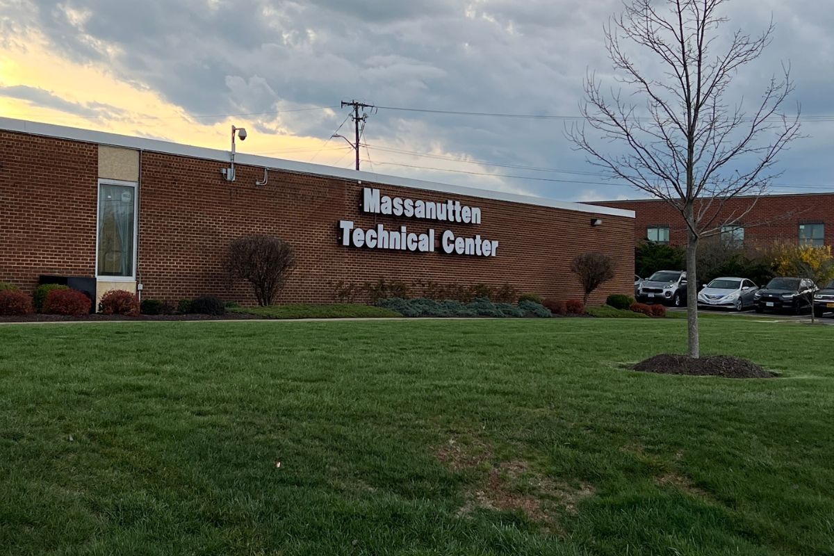 A brick building with big letters on it that says Massanutten Technical Center.