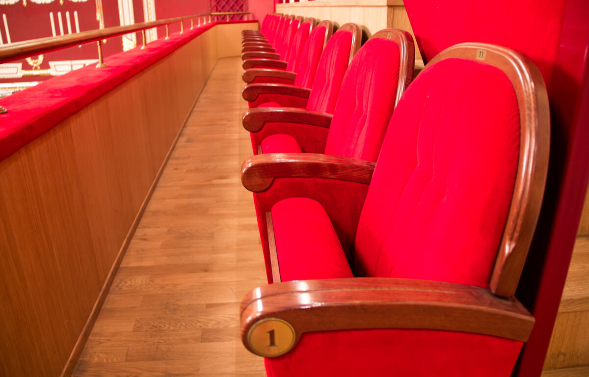 A row of red seats in a theater.