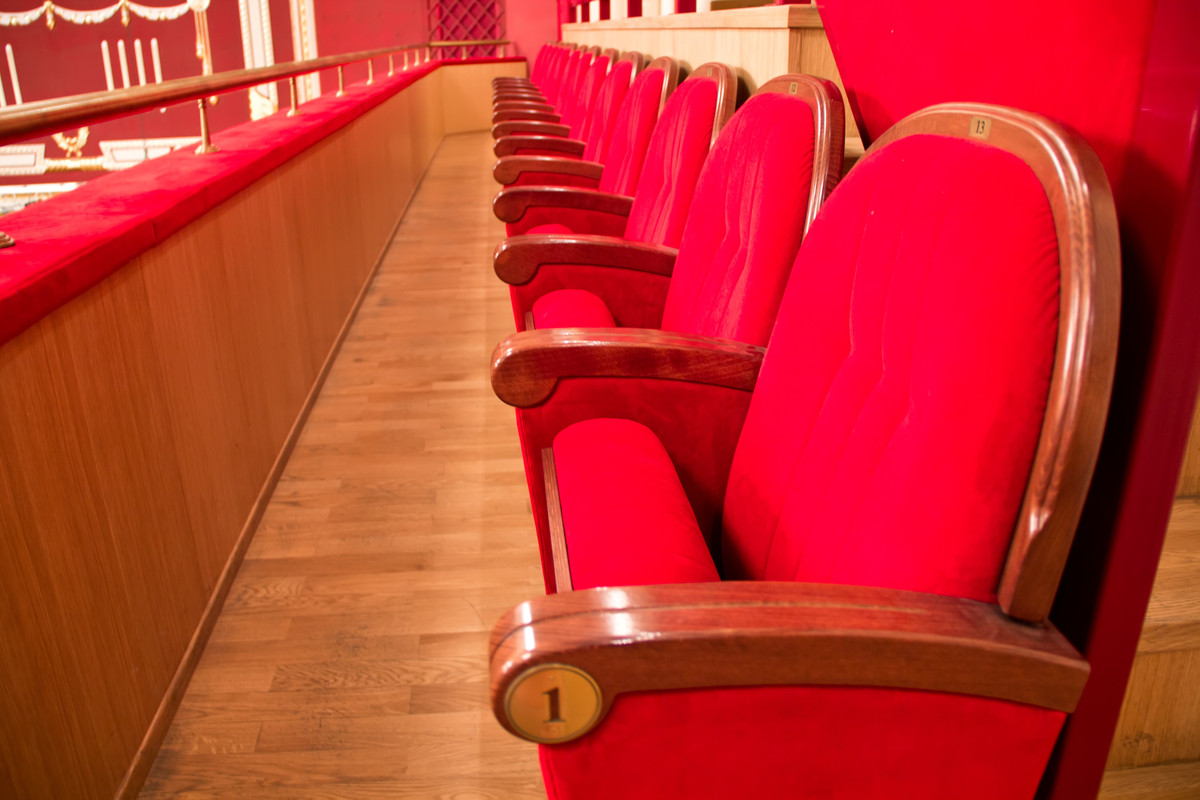 A row of red seats in a theater.