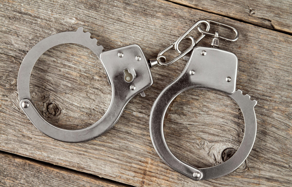 Top view of handcuffs on the wooden background