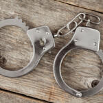 Top view of handcuffs on the wooden background