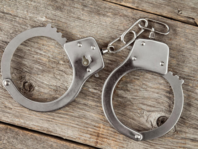 Top view of handcuffs on the wooden background