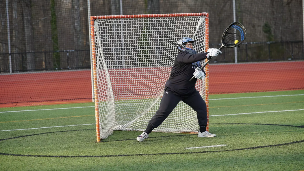 An Eastern Mennonite University goalie stops the ball from entering the net.