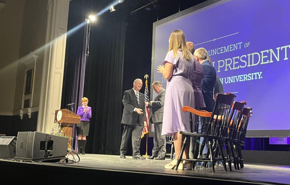 Dr. James C. Schmidt gets sworn in on stage with several James Madison University officials.