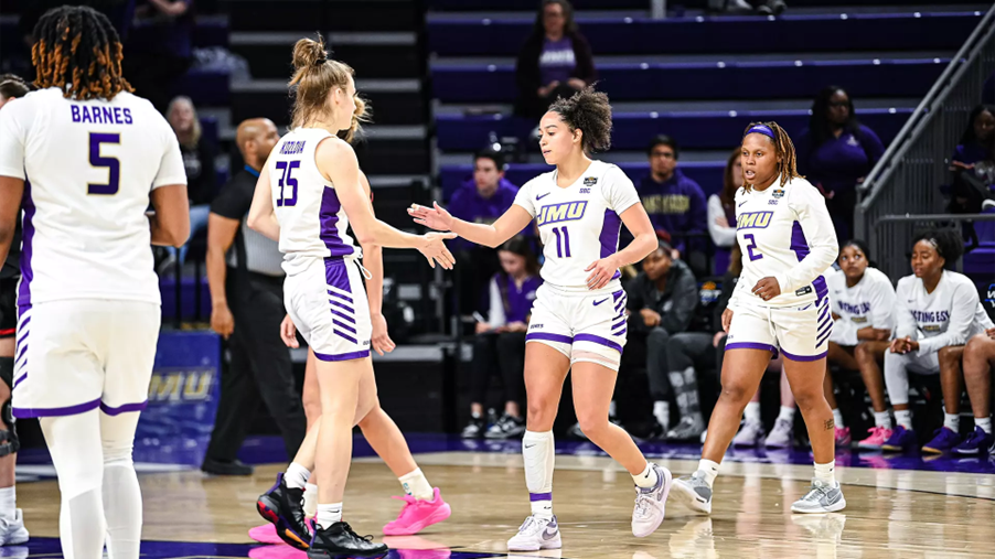 James Madison University Women's Basketball players shake hands on the court
