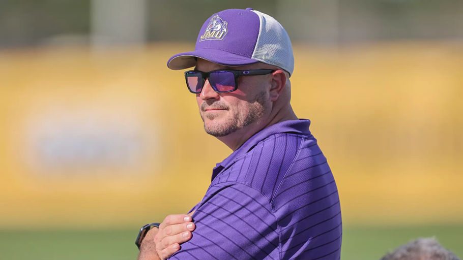 James Madison University women's soccer Head Coach Joshua Walters, Sr stands on the field.