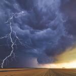 Clouds with a lightning strike in a field