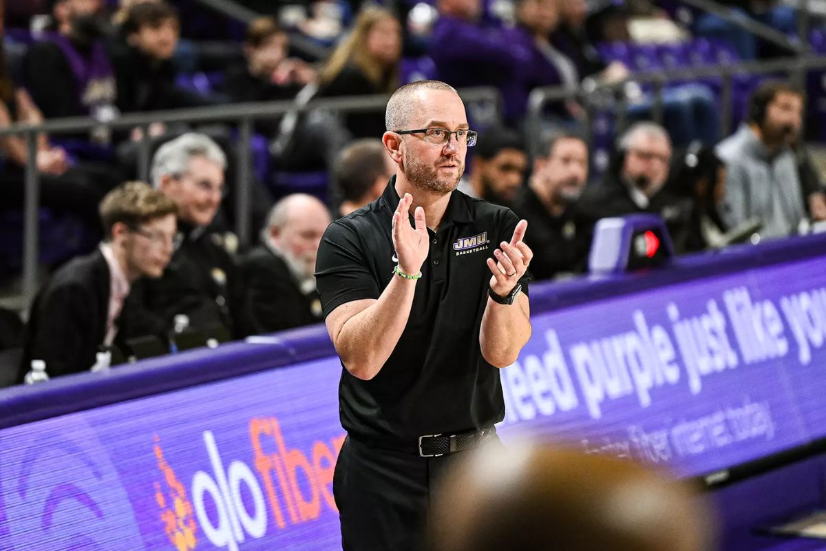 Head coach Sean O'Regan claps hands courtside.