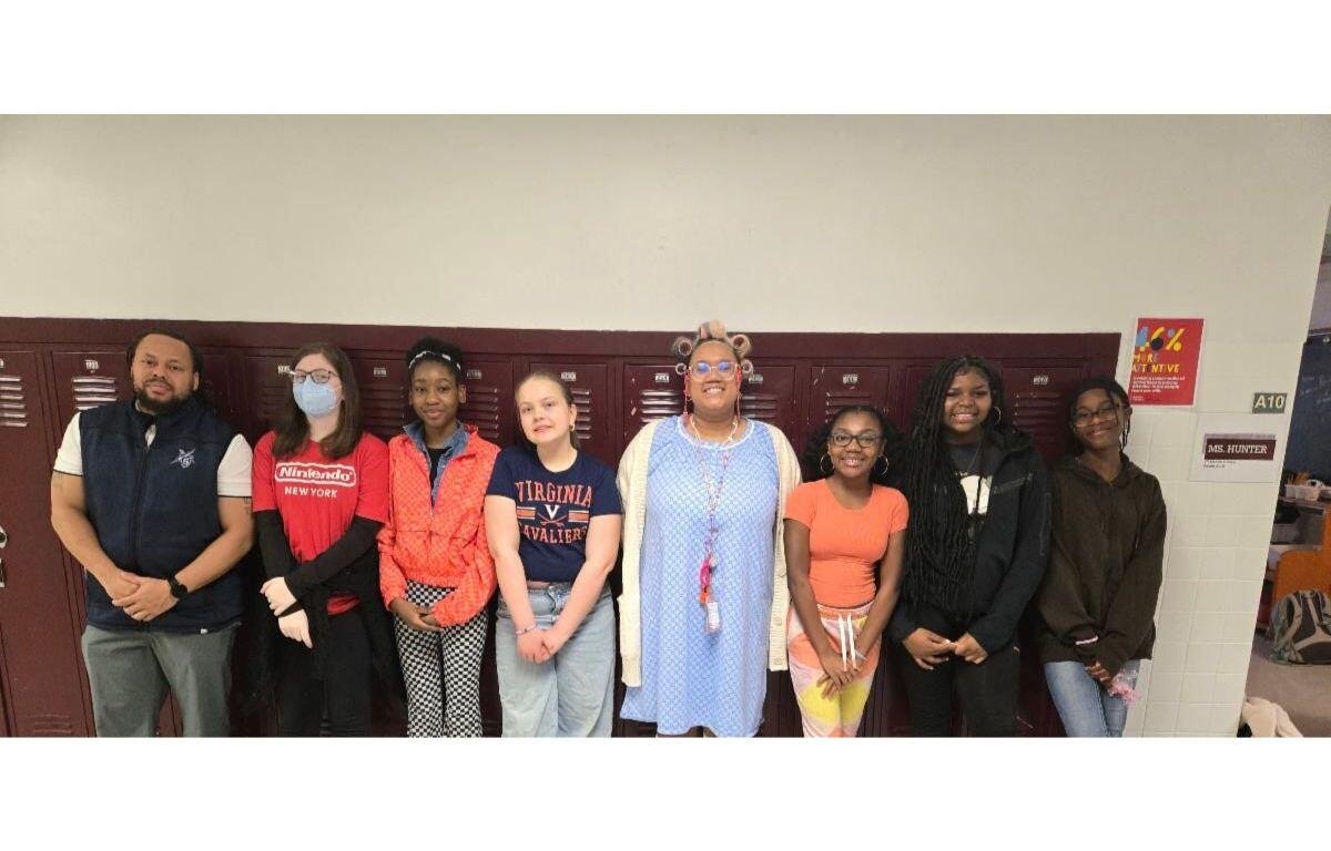 Shelburne Middle School students who are competing in National Civics Bee standing in front of lockers.