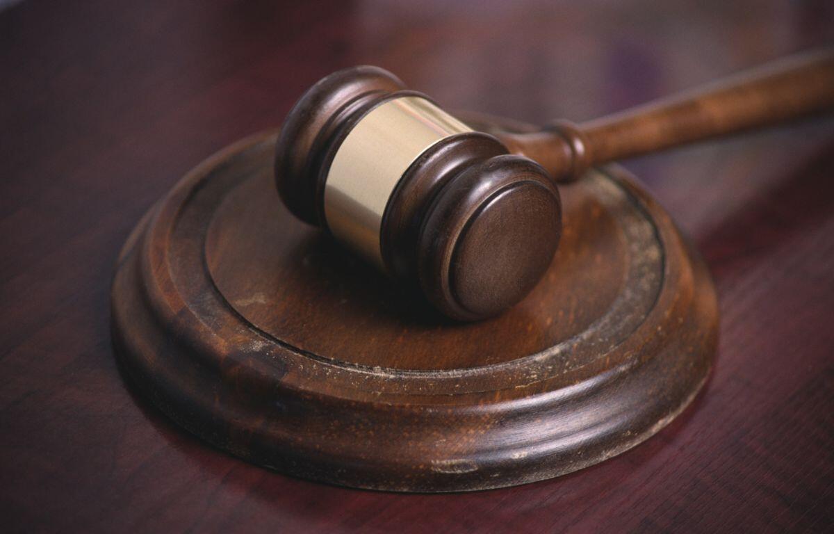 A gavel sits on a desk.