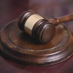 A gavel sits on a desk.