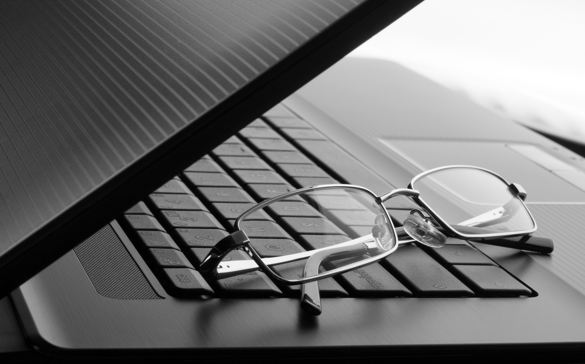 Businessman's glasses on laptop computer