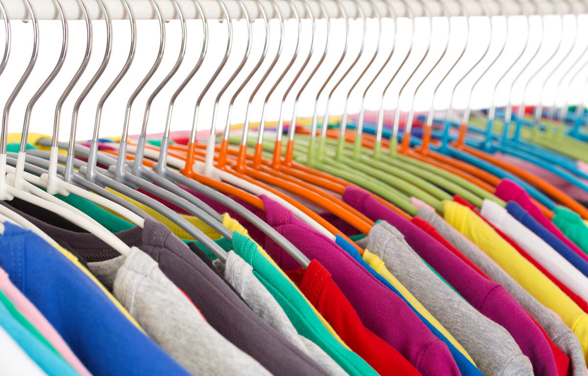 Collection of colored shirts on steel hangers. Isolate. Shallow depth of field.
