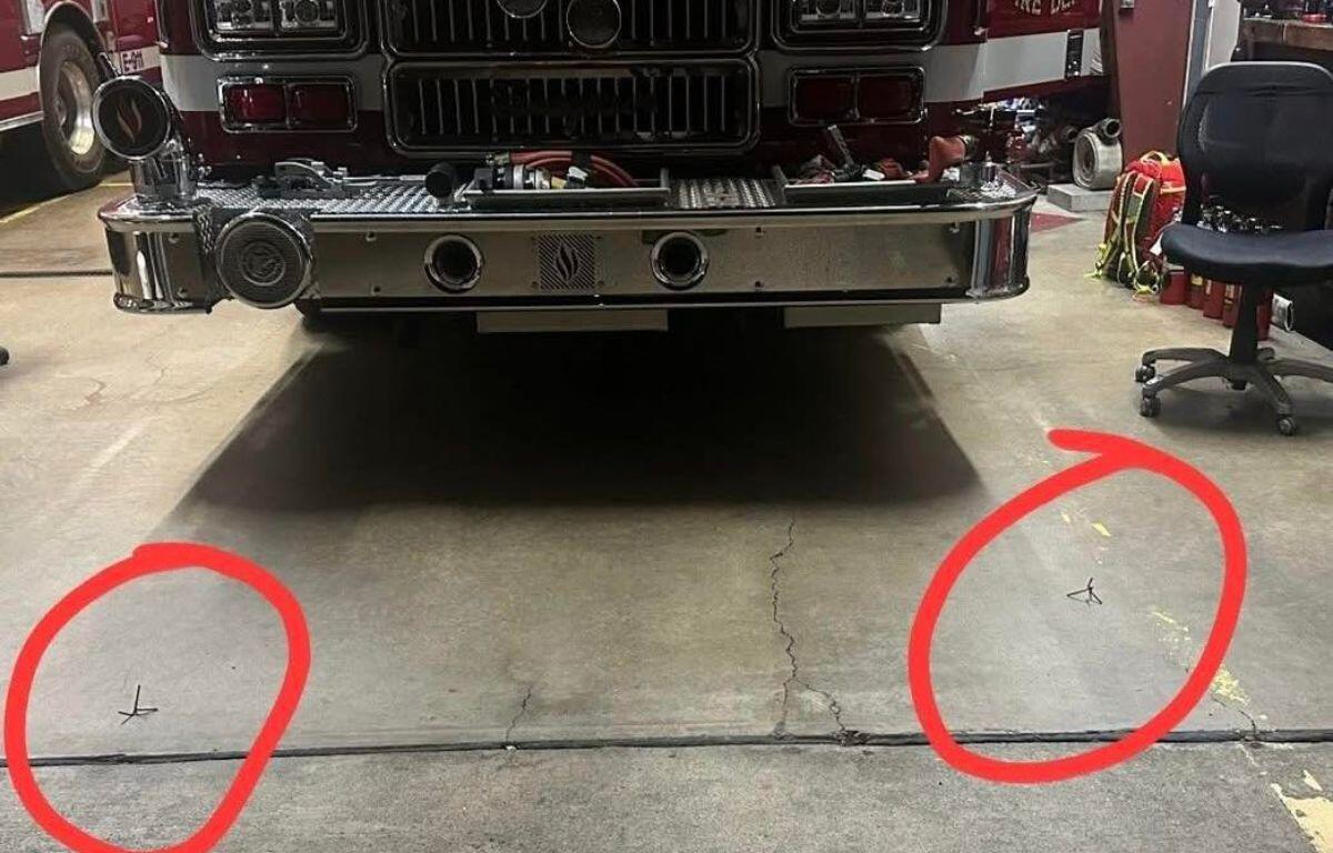 Photo showing spikes in front of fire engine tires with red circles showing where the spikes are located