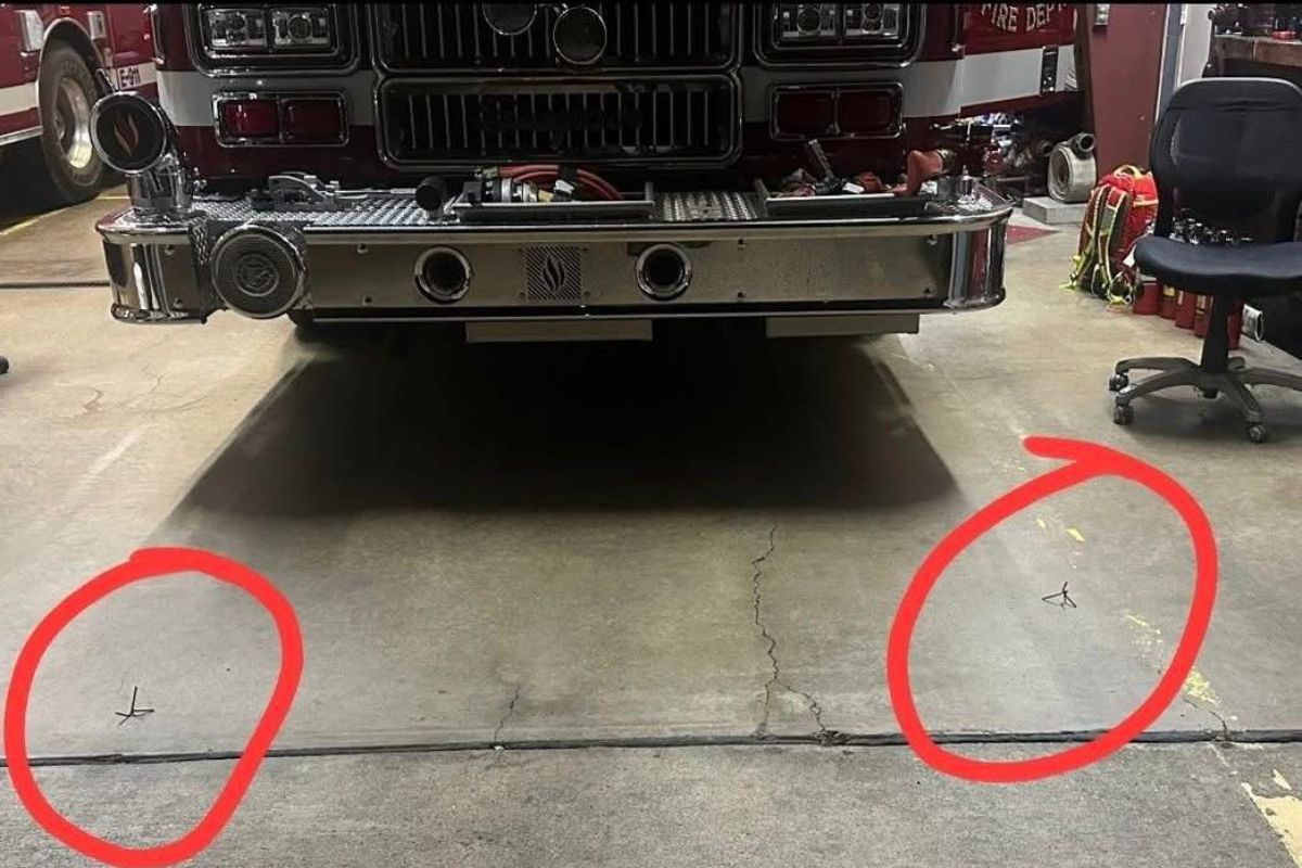 Photo showing spikes in front of fire engine tires with red circles showing where the spikes are located