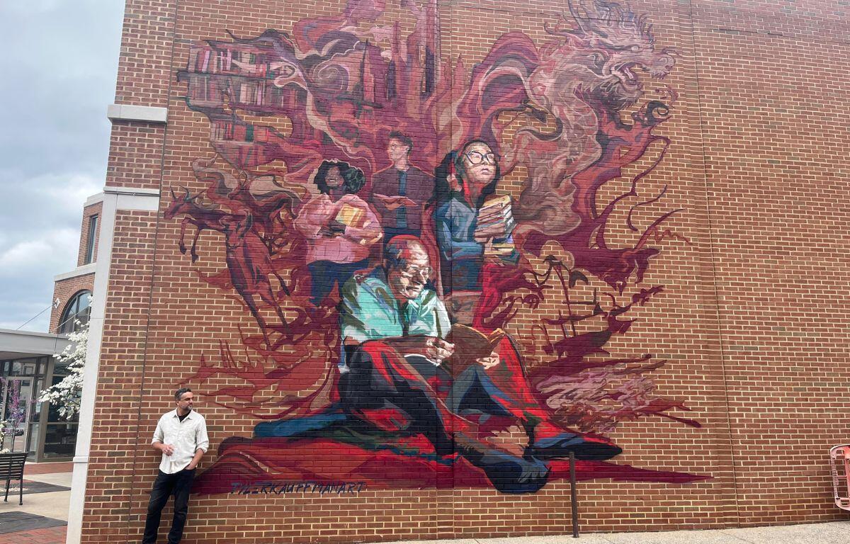 Tyler Kauffman in front of the Massanutten Regional Library Mural