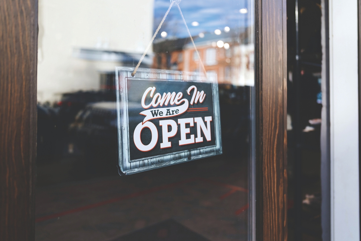 A close up of an open sign on a door.
