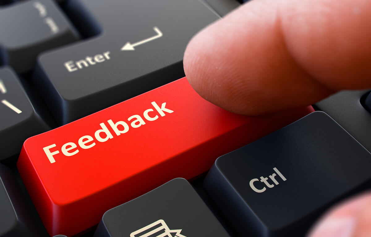 Feedback Button. Male Finger Clicks on Red Button on Black Keyboard. Closeup View. Blurred Background. 3d Render.