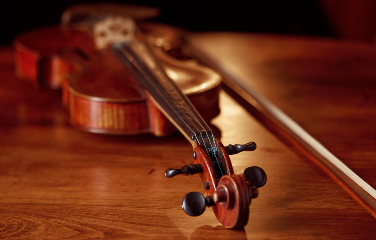 Violin in retro style on wooden table, closeup