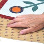 A hand on a quilt