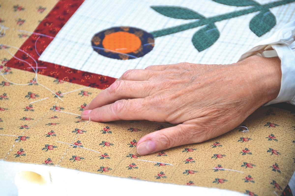 A hand on a quilt