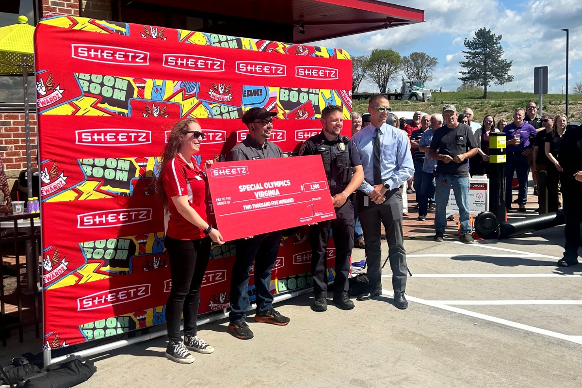 The Special Olympics of Virginia being presented a giant cardboard check for $2,500.