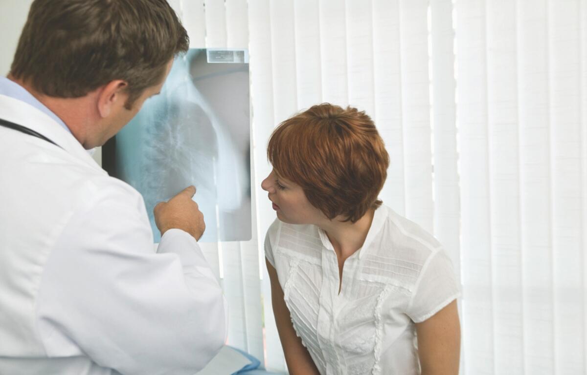 A doctor showing a patient an x-ray.