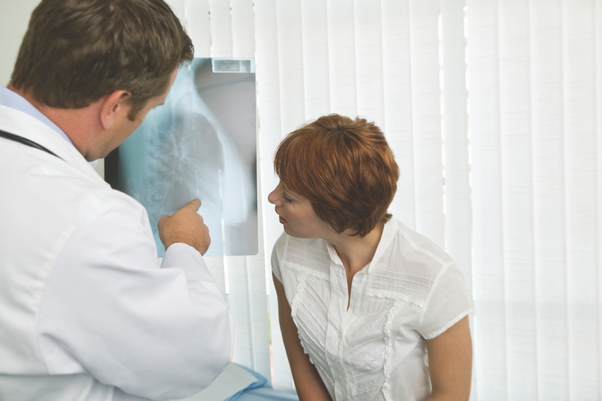 A doctor showing a patient an x-ray.