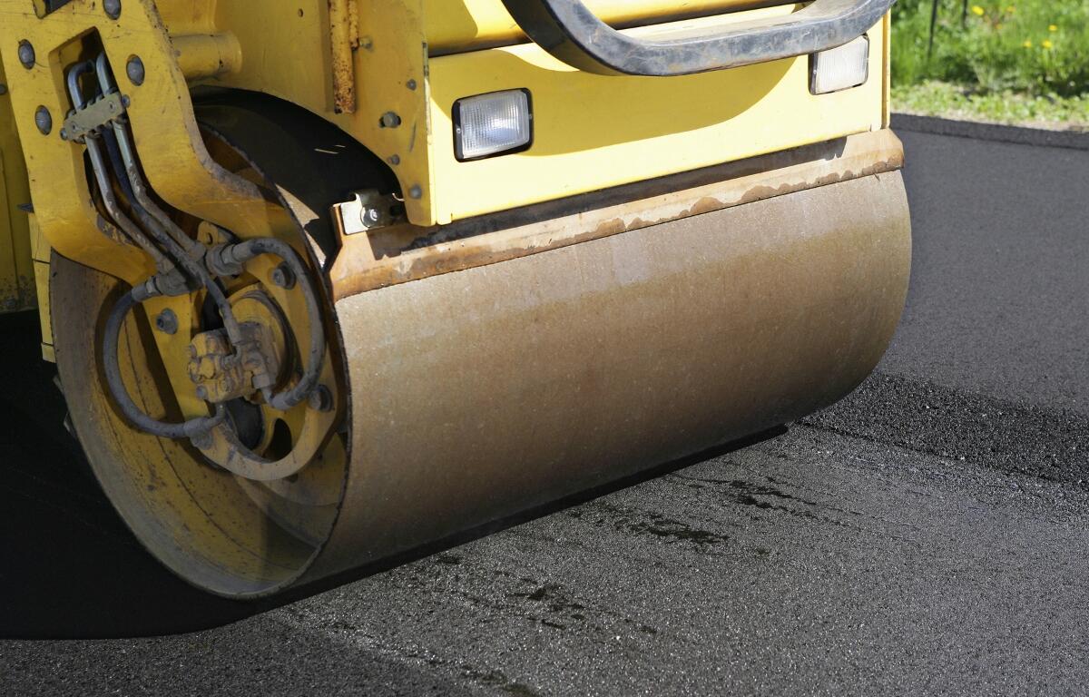 A large paver rolling on a road.