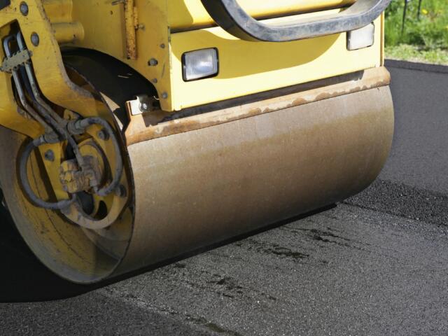 A large paver rolling on a road.