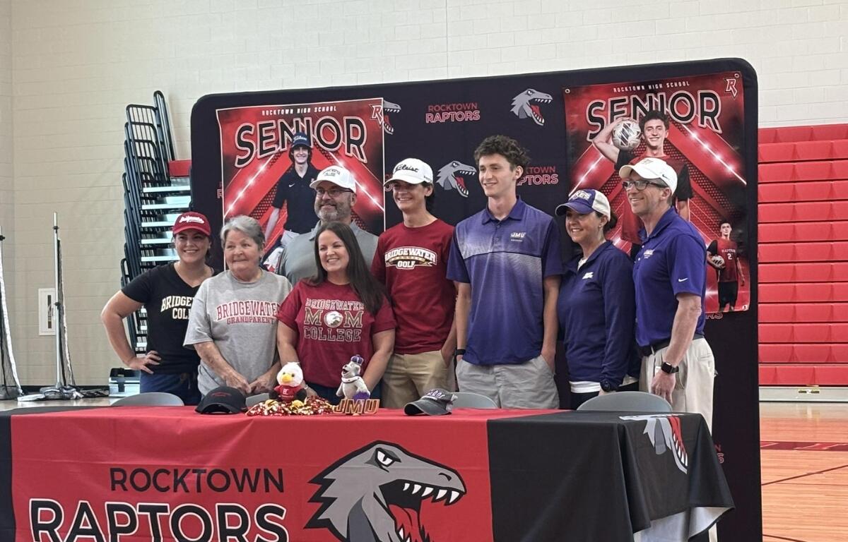 Tyler and Landon with their families after they signed with local colleges.
