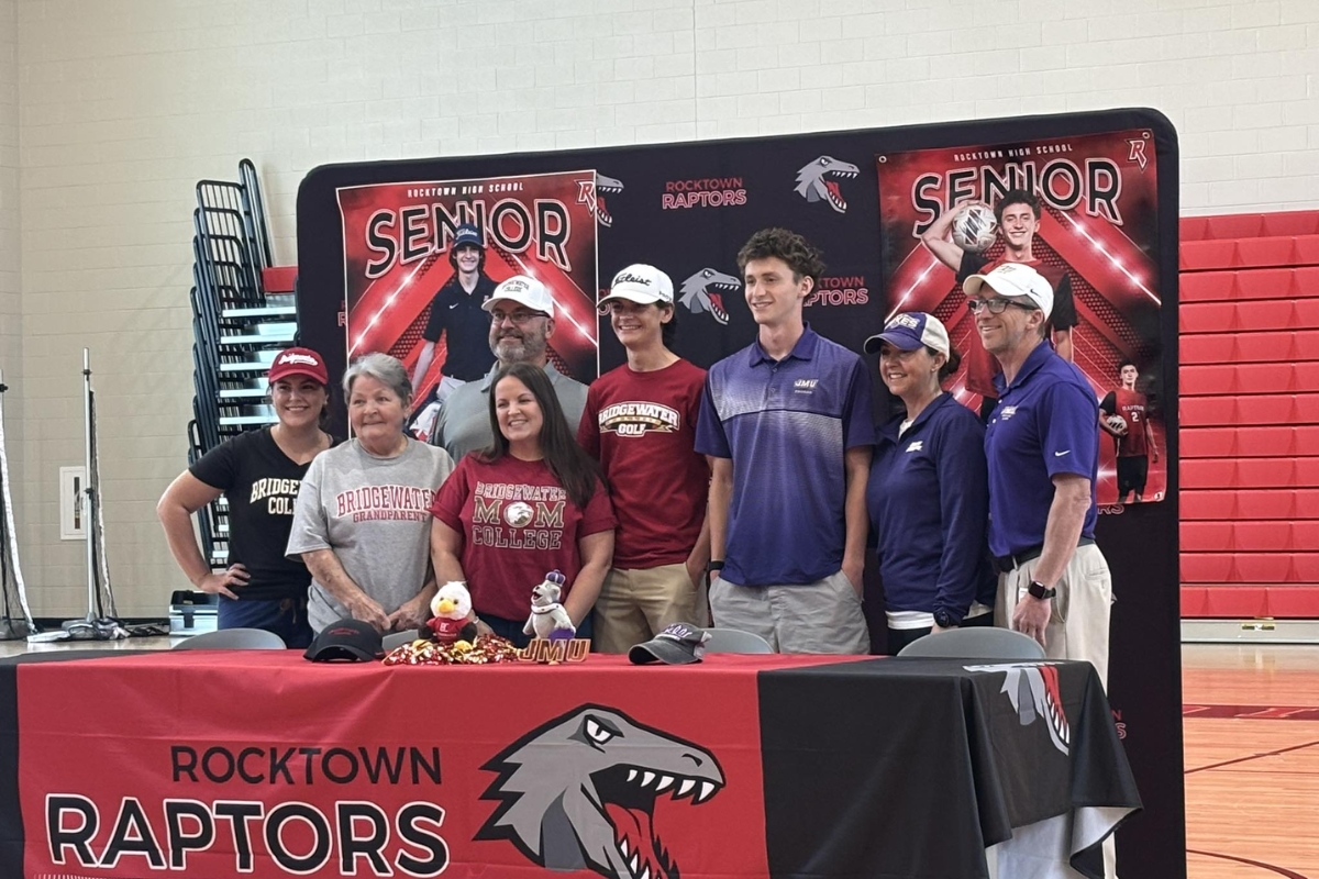 Tyler and Landon with their families after they signed with local colleges.
