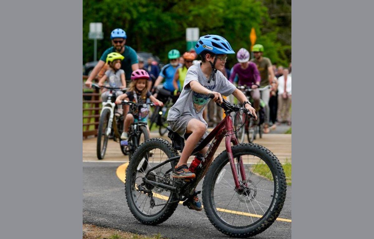 A family bicycles on a trail in Harrisonburg. The Harrisonburg Happy - Family Friendly Travel campaign highlights things families can do when visiting Harrisonburg