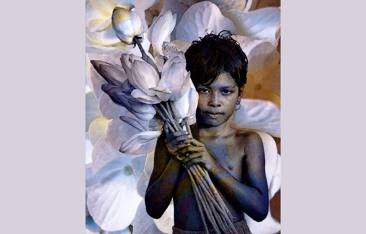 Boy holding a flower with various colors throughout the mural