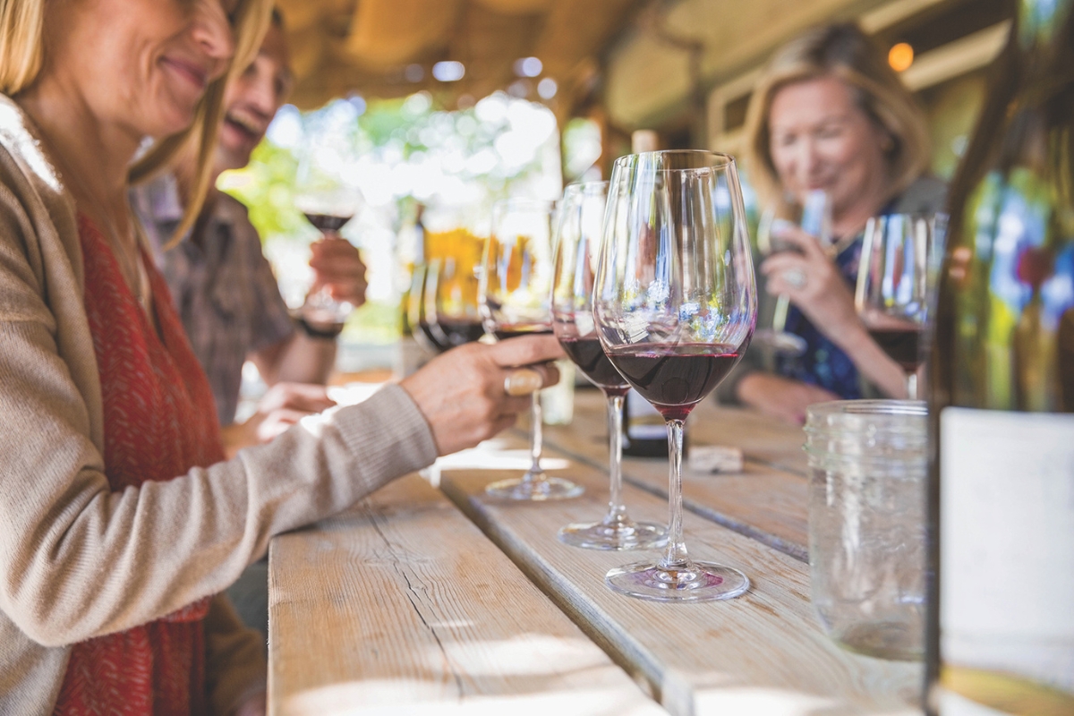 A group of people enjoying a wine tasting.