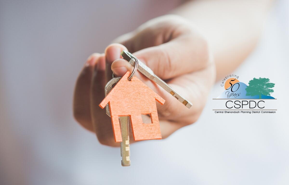 A hand holding out keys