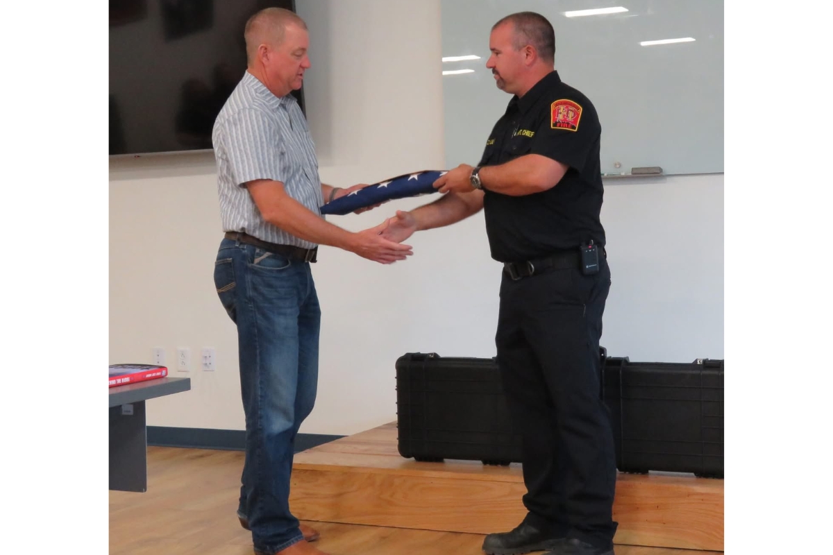 Mike Armstrong receives a flag flown over the Capitol.