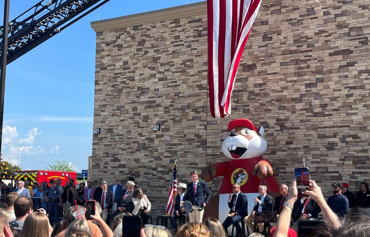 Government officials stand in front of the Buc-ee's entrance to celebrate the grand opening.