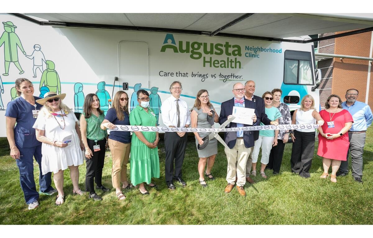 Many Augusta County officials cut the ribbon for their new mobile unit.