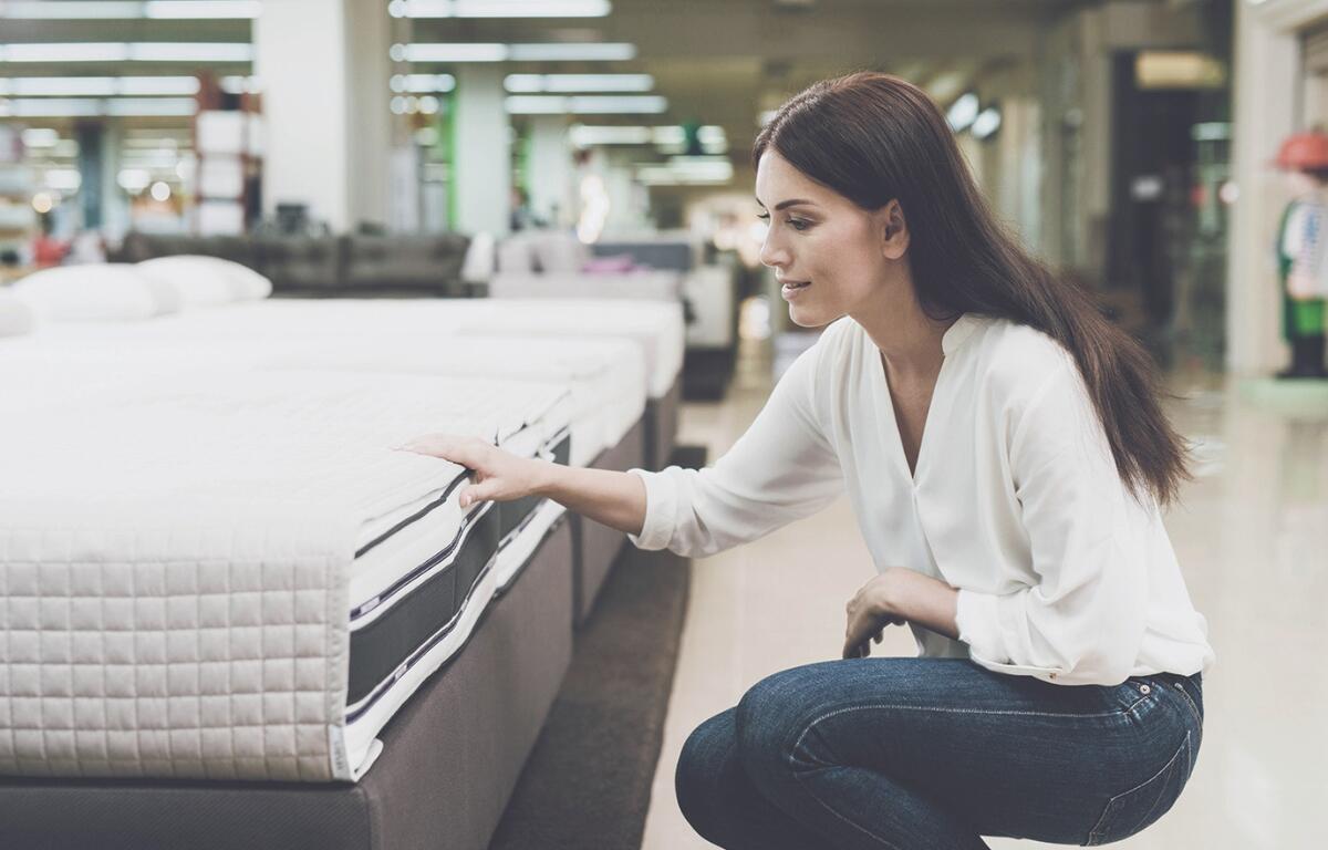 A person shopping for mattresses.