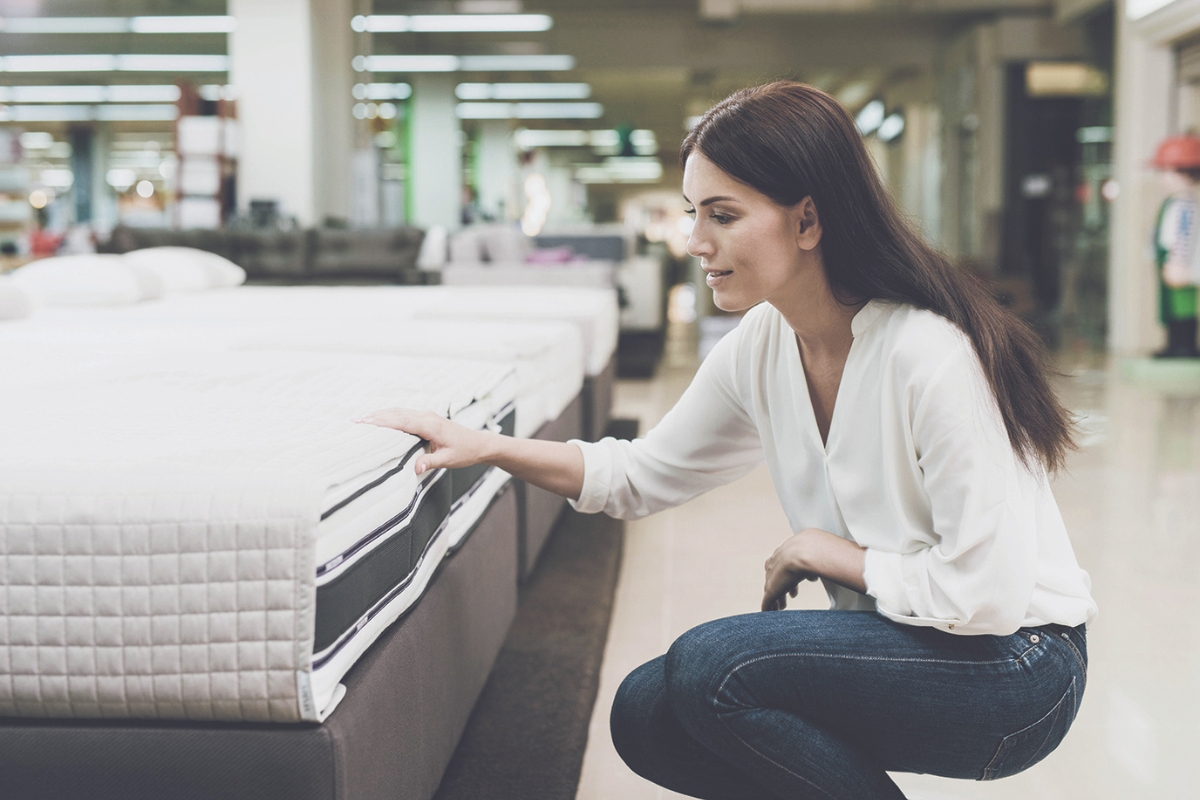 A person shopping for mattresses.