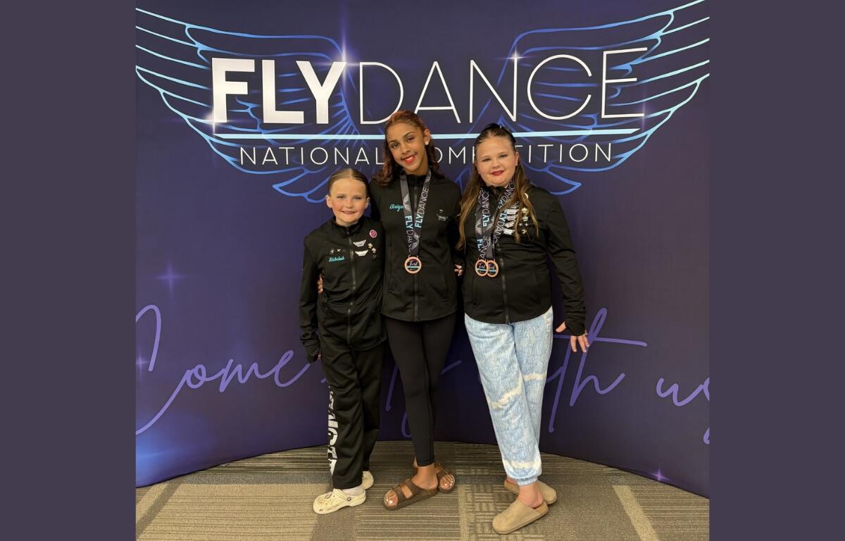 Rebekah Manley, Aniyah Hodgins, and Elizabeth Manley stand together to represent Elkton Expressive Dance Studios.