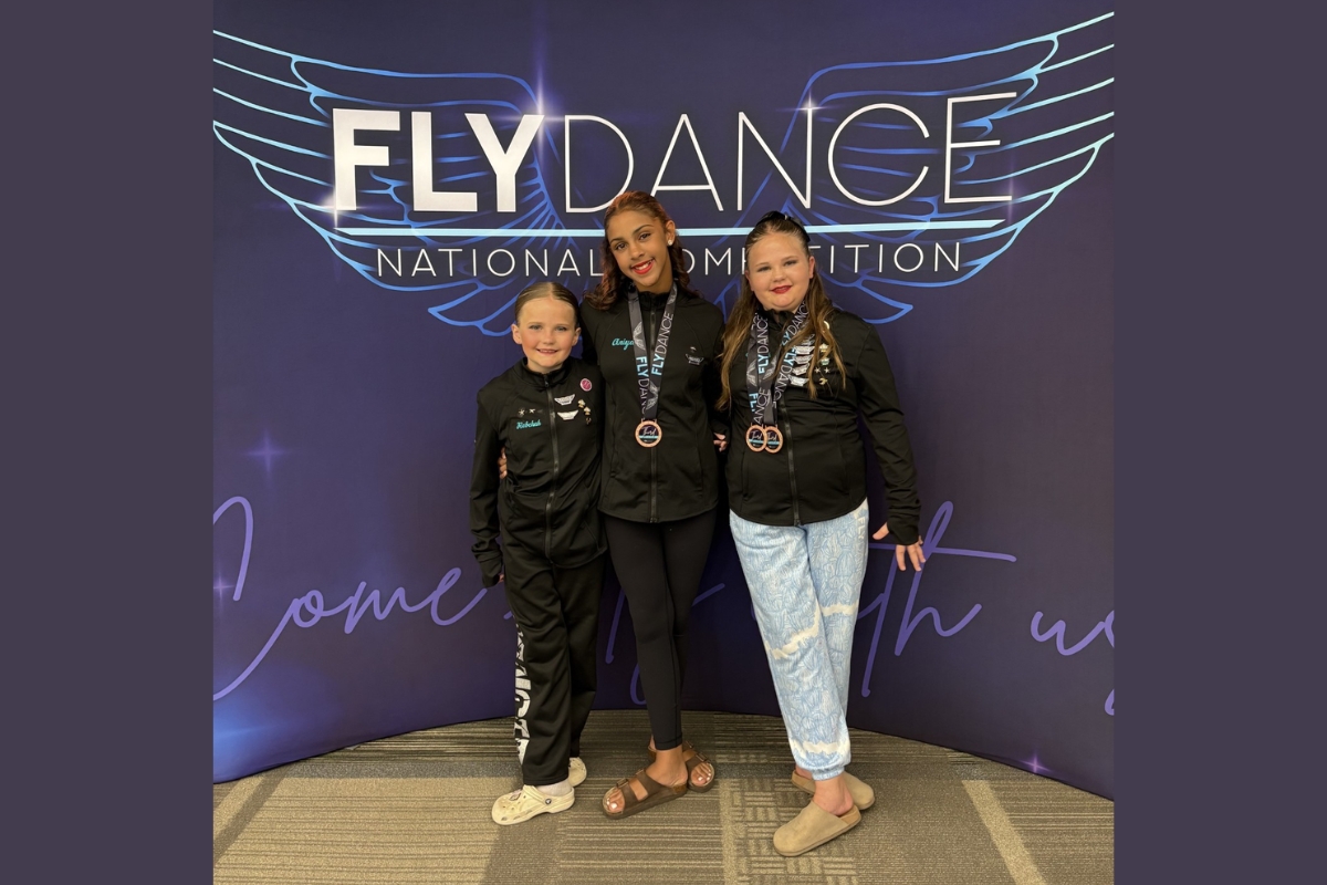 Rebekah Manley, Aniyah Hodgins, and Elizabeth Manley stand together to represent Elkton Expressive Dance Studios.