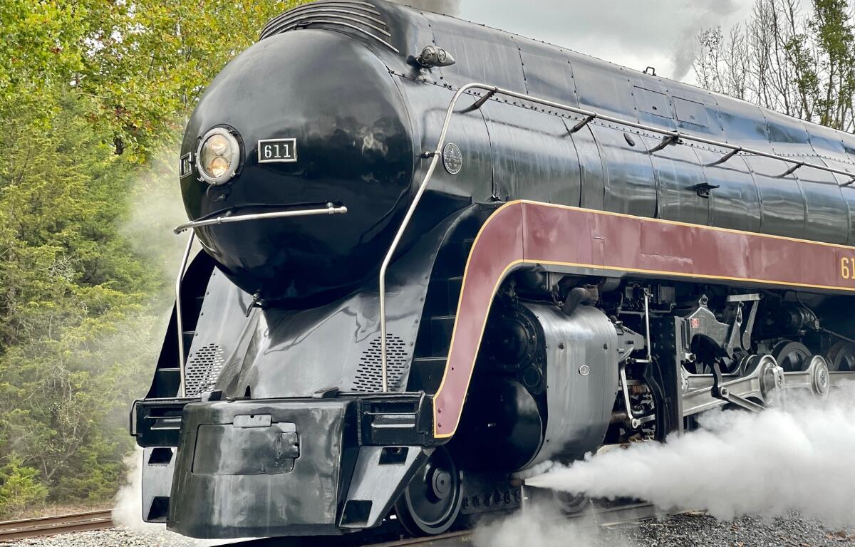 Up close of the 611 locomotive. A large black train.