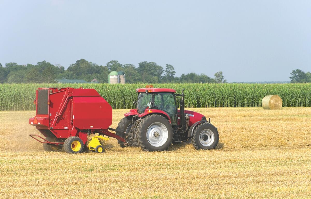 A tractor harvesting hay