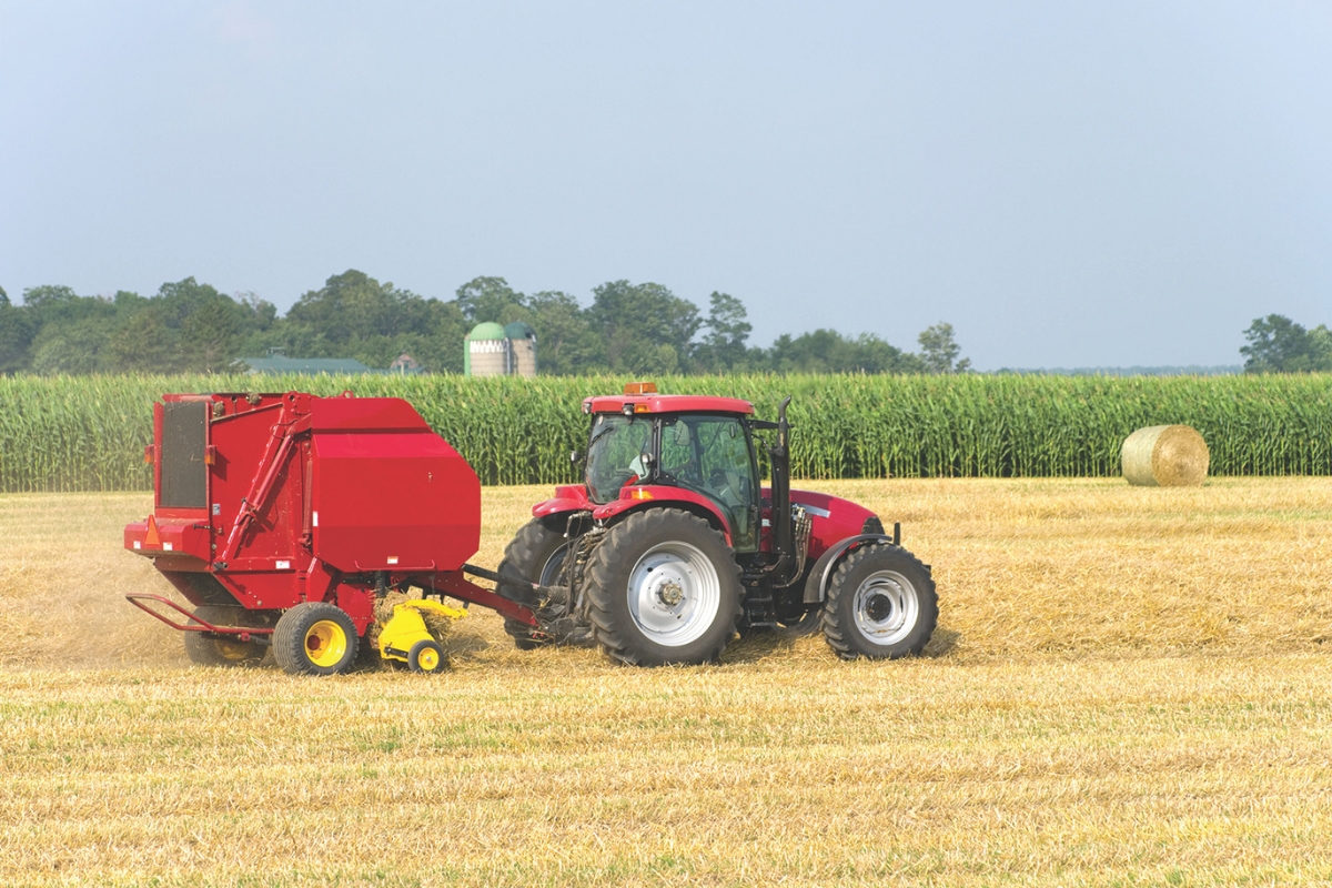 A tractor harvesting hay